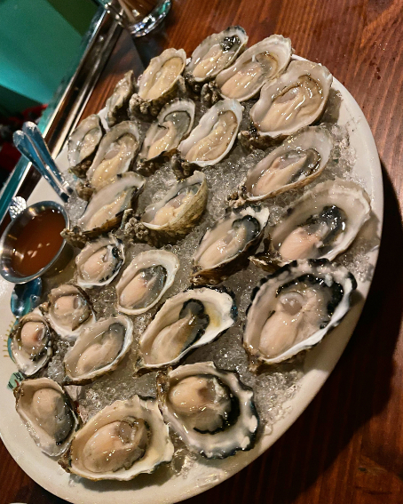 Oysters on ice with cocktail sauce.