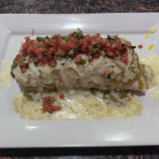 A burrito with melted cheese and pico de gallo from Casa de Reyes.
