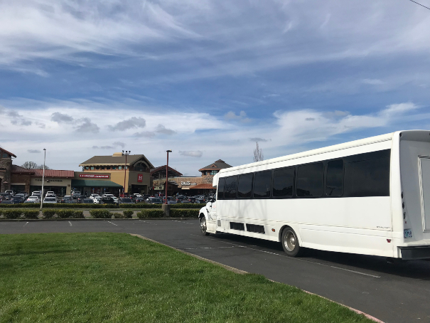 A tour bus parked in front of the Woodburn Outlet Mall.