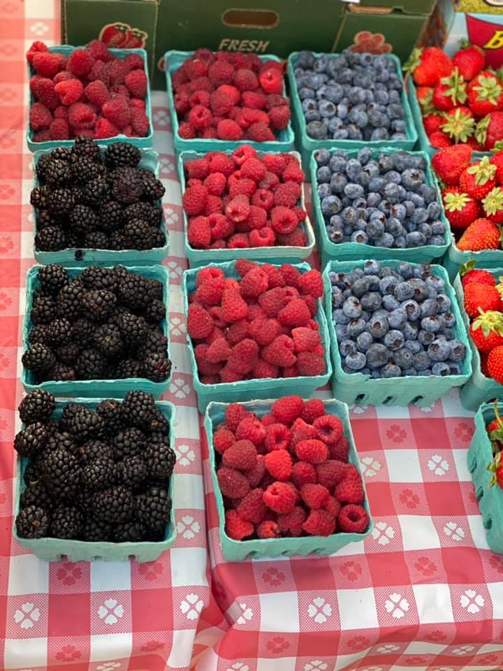 Blackberries, raspberries, blueberries, and strawberries on top of a table.