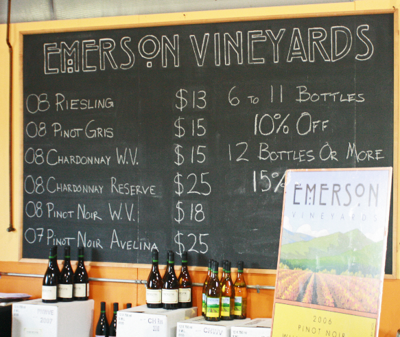 Blackboard sign showing the wine options for sale.