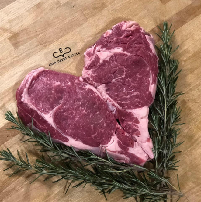 Two steaks shaped into a heart.