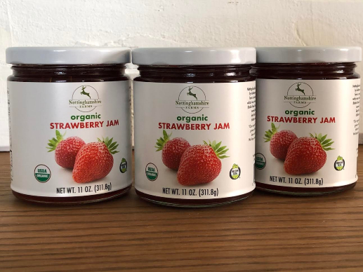 Organic strawberry jam in jars for sale.
