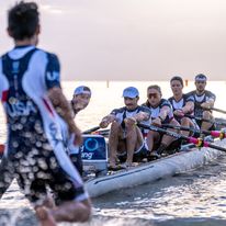 A team of people rowing a boat in a rowing competition