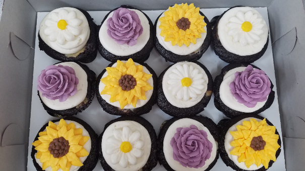 Cupcakes decorated as different type of flowers.