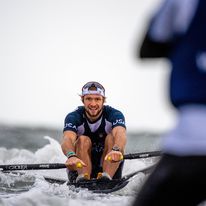 A man competing in a rowing event.
