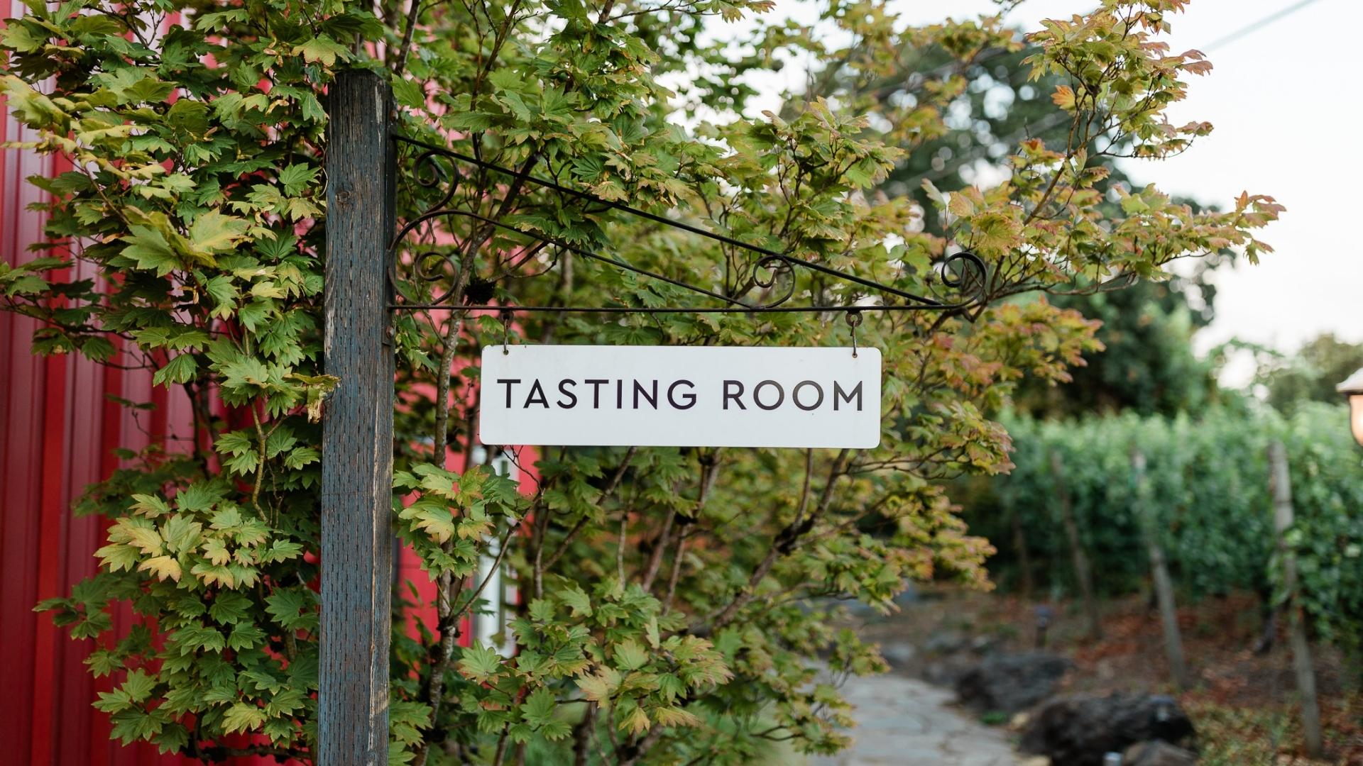 A sign for a tasting room at a winery.
