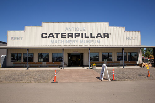 exterior of commercial building with sign for Antique Caterpillar Machinery Museum