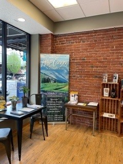 interior of visitor information center with wood flooring, brick walls and a table and two chairs