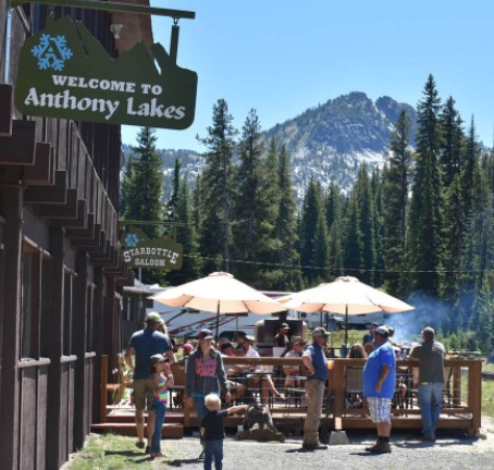outdoor seating featuring patio and umbrellas with signs for Starbottle Saloon and Welcome to Anthony Lakes