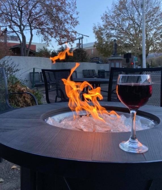 outdoor fire pit with glass of wine sitting on the ledge
