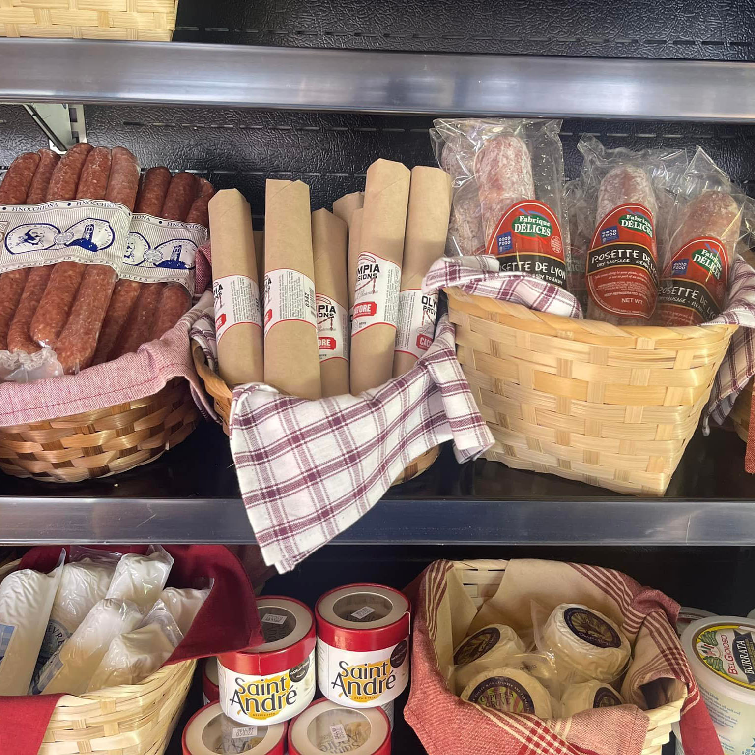 retail display of meat sticks and cheeses