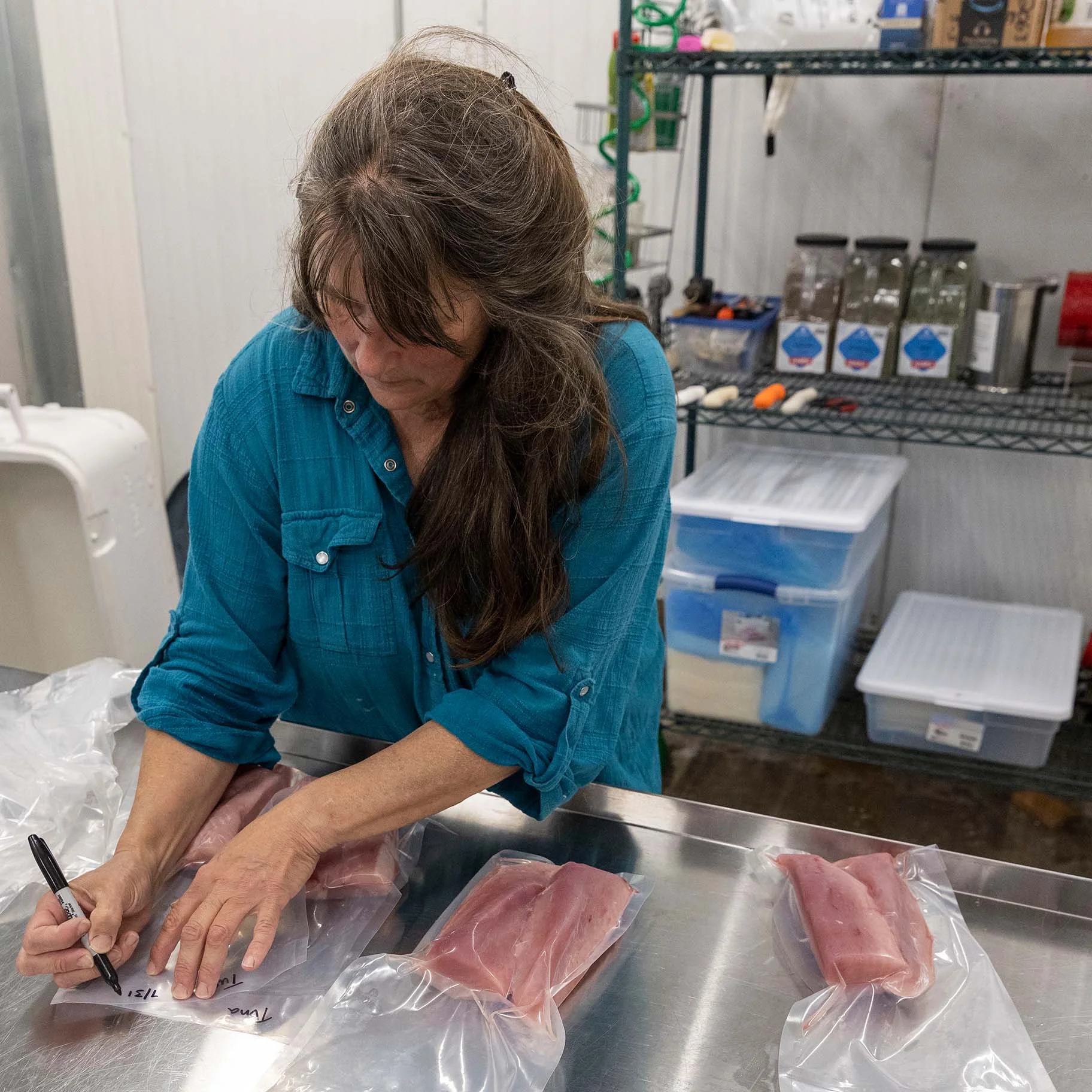 Little Fine Fine Seafood Market Co-Owner Greta Horn labelling Albacore tuna for the freezer_.jpg
