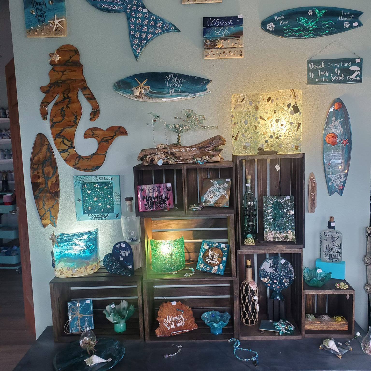 retail art display with creations displayed on wall and shelves