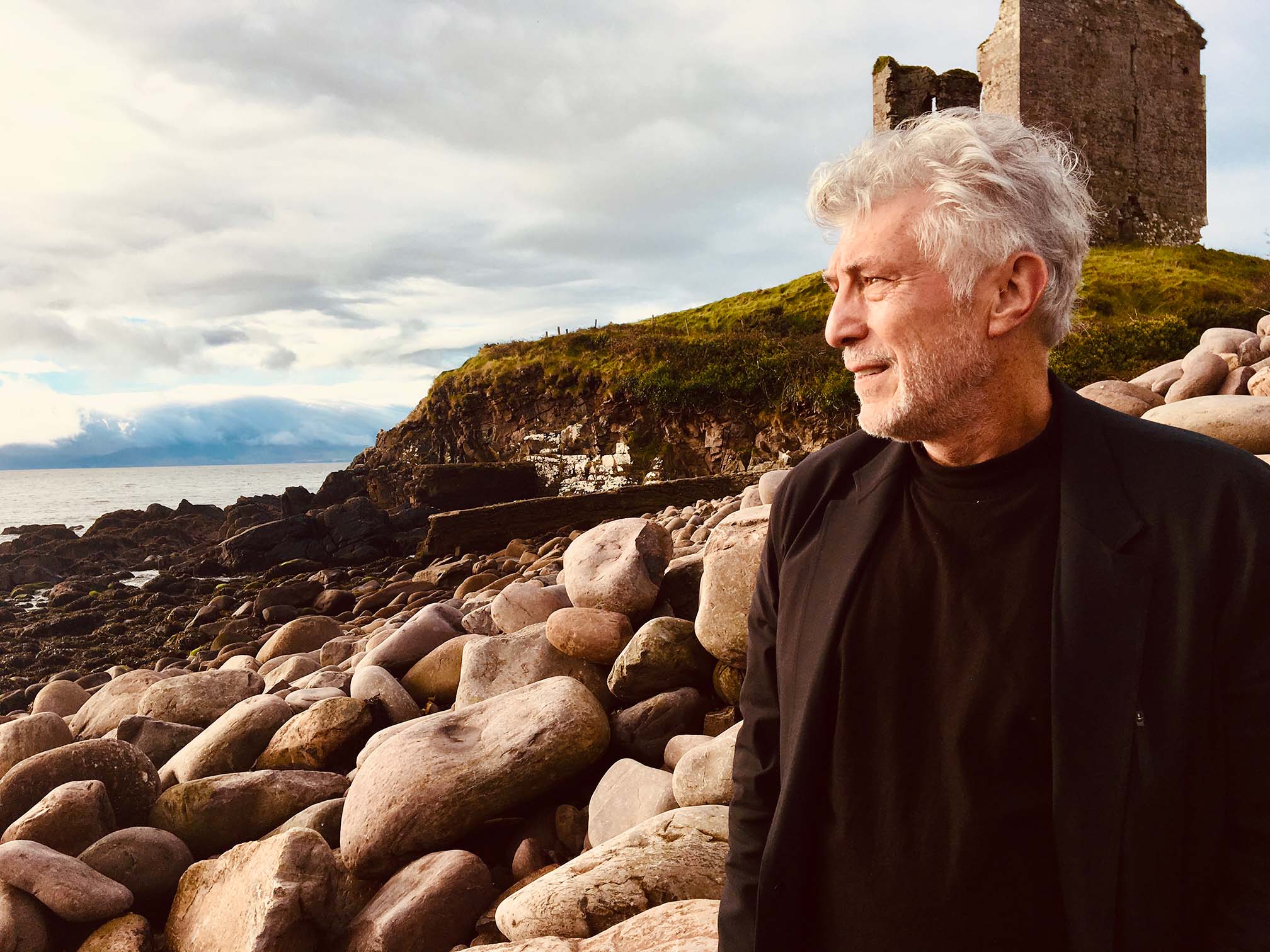 Randall Sullivan author standing on rocky shore