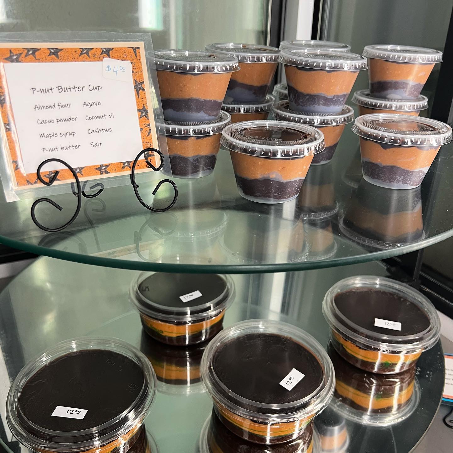 retail display of homemade peanut butter cups in small containers with lids