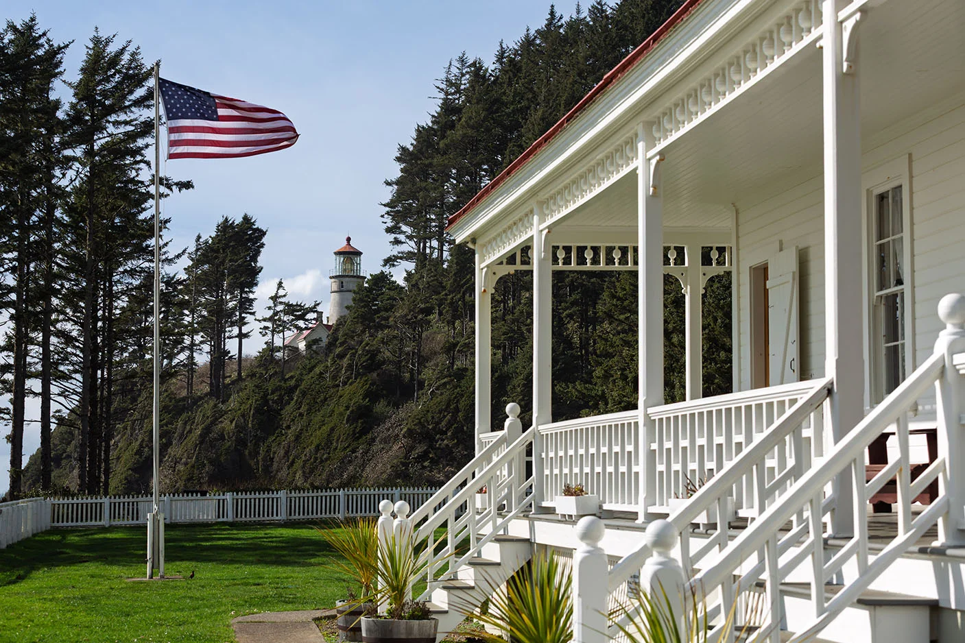 Heceta Lighthouse B&B exterior with lighthouse in the distance