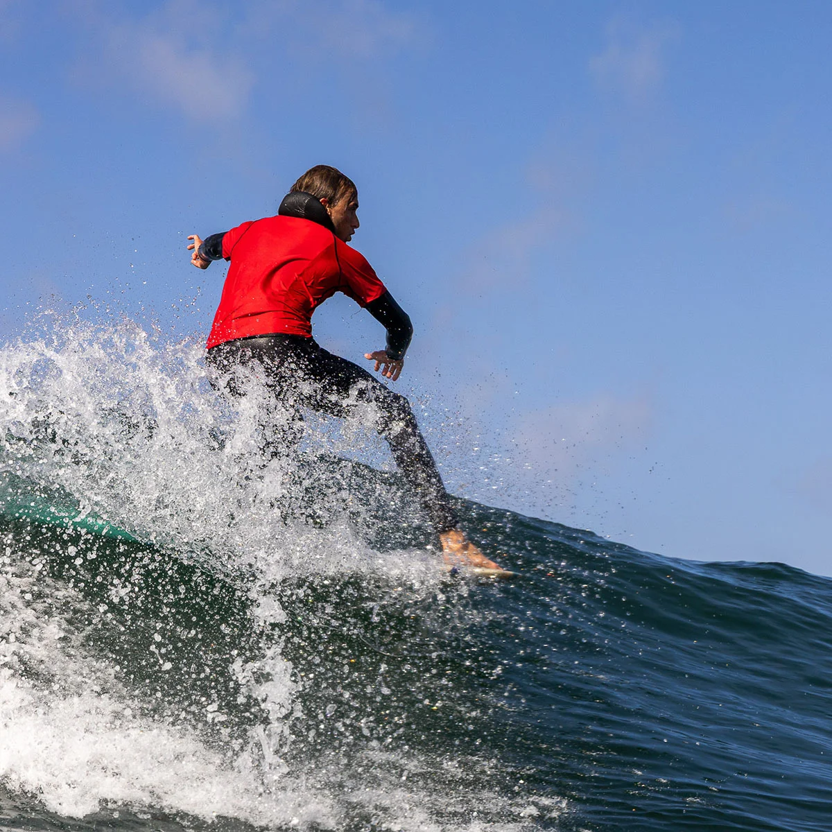 surfer surfing on big wave at Cape Kiwanda Longboard Classic