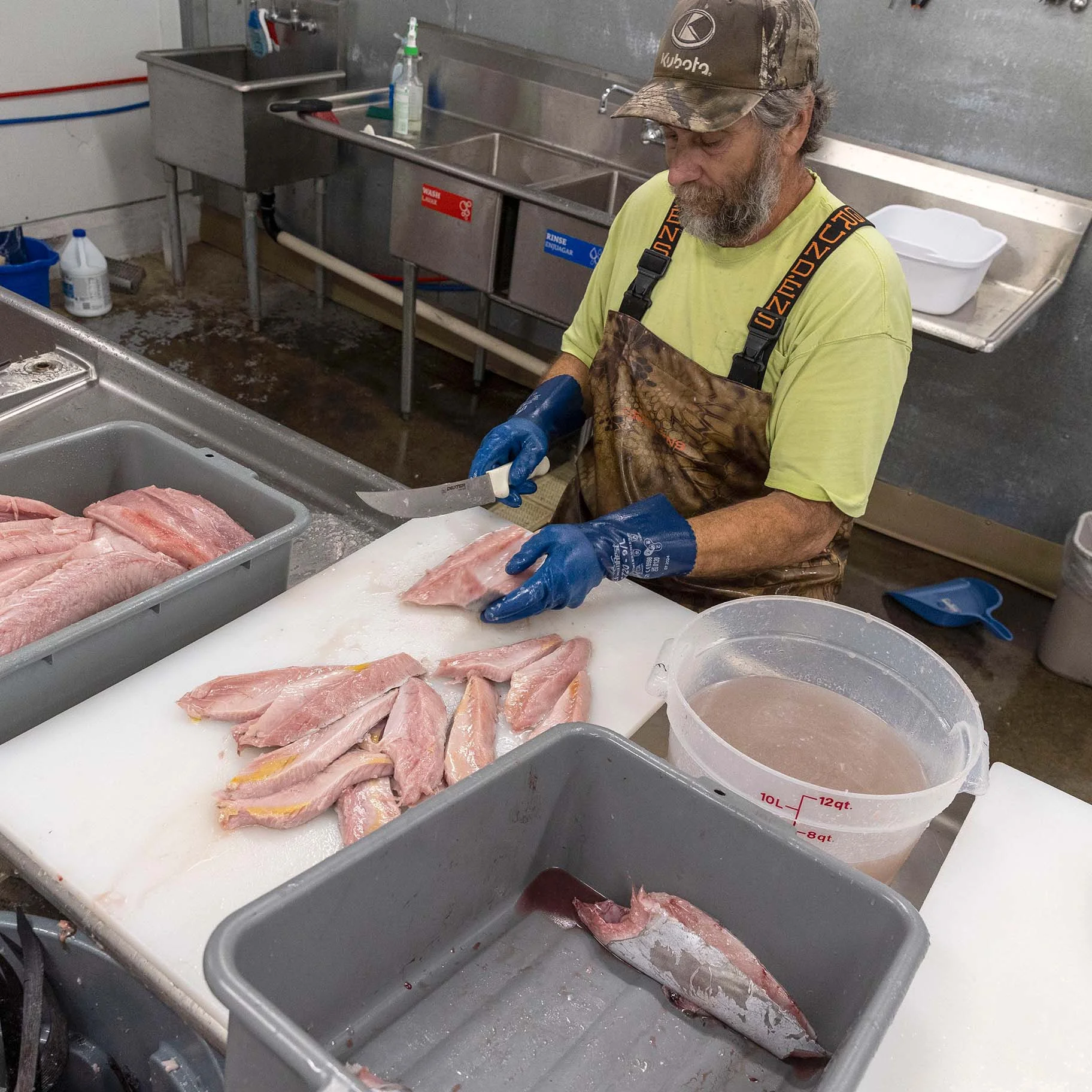 Little Fish Fine Seafood Market Co-Owner Casey Horn processing Albacore tuna loins.JPG