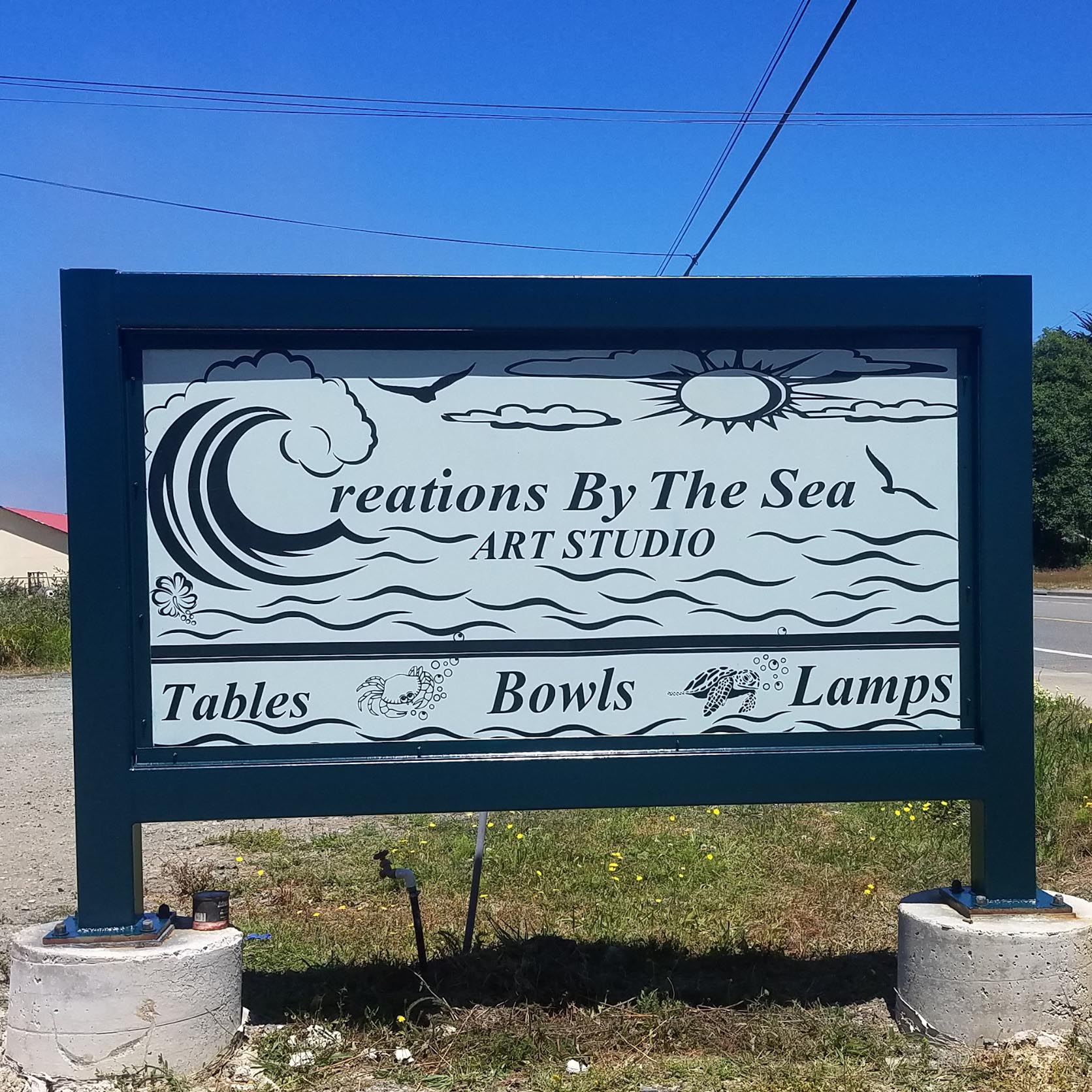 outdoor sign with text for Creations By The Sea Art Studio
