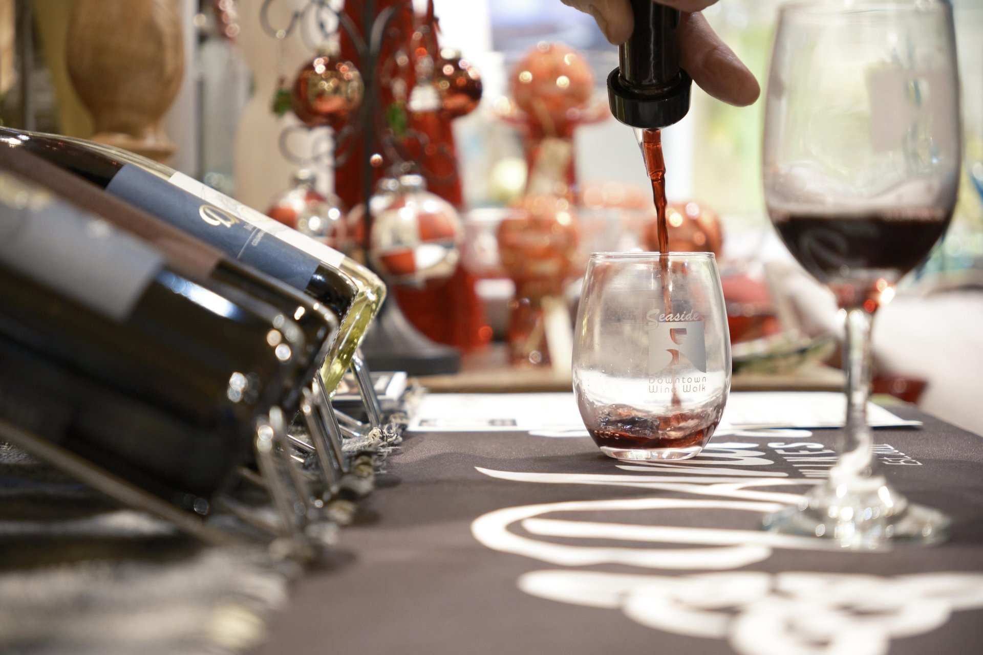 Pouring wine glass at Downtown Fall Wine Walk wine tasting Seaside Oregon