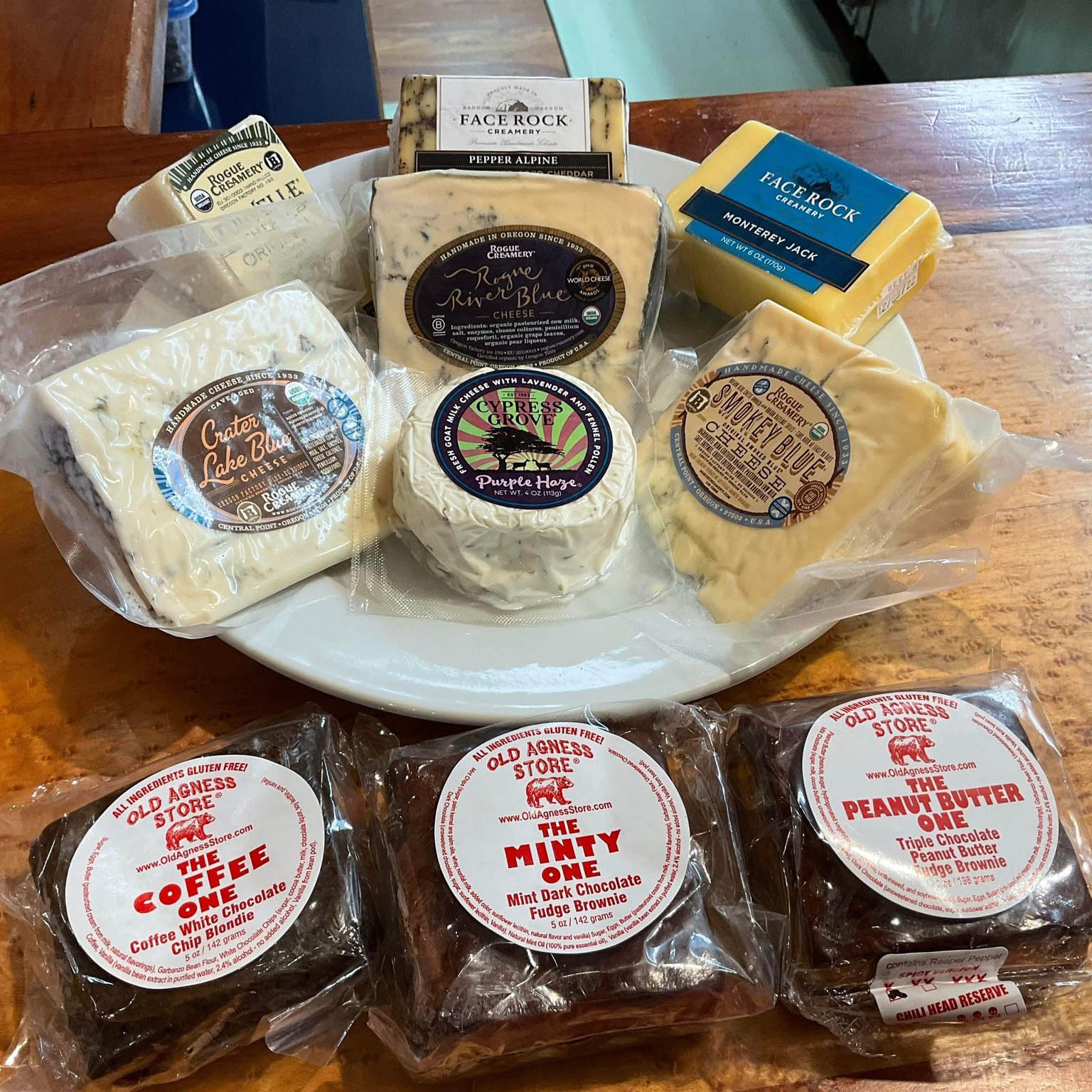 retail display with plate of packaged artisanal cheeses and brownies