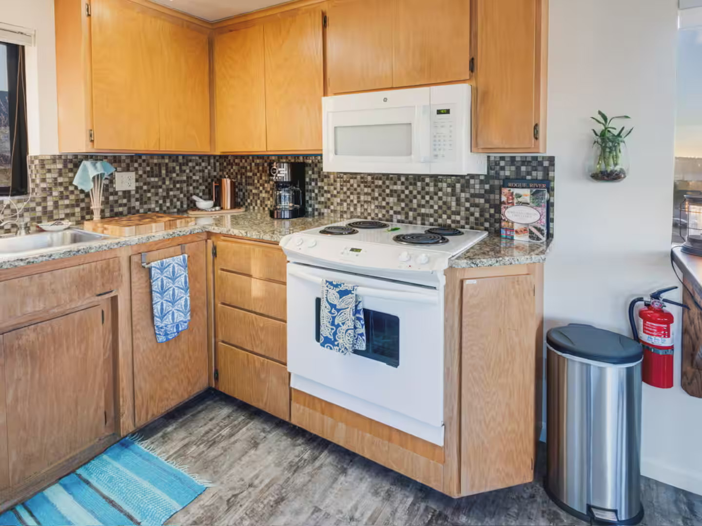 small kitchen with brown cupboards and electric range