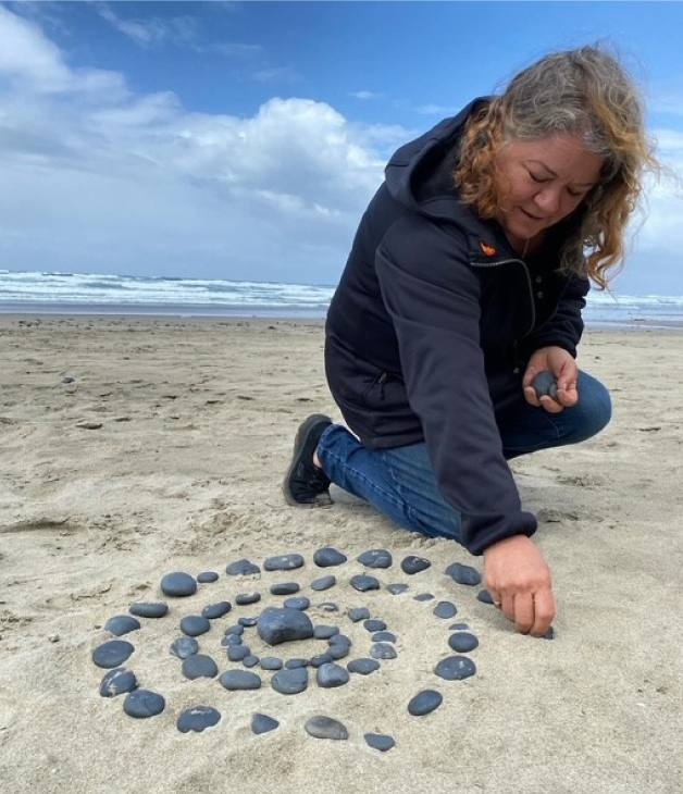 Hallie Moore arranging stones on the beach