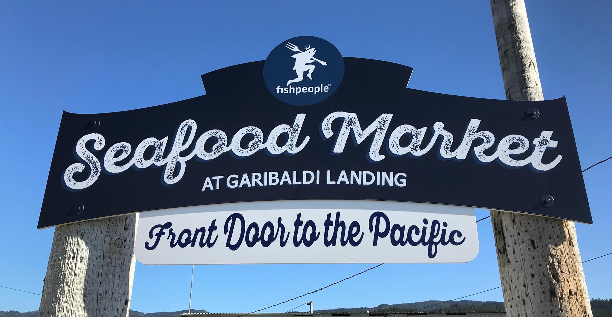 Blue sign that reads Fishpeople Seafood Market at Garibaldi Landing, Front Door to the Pacific