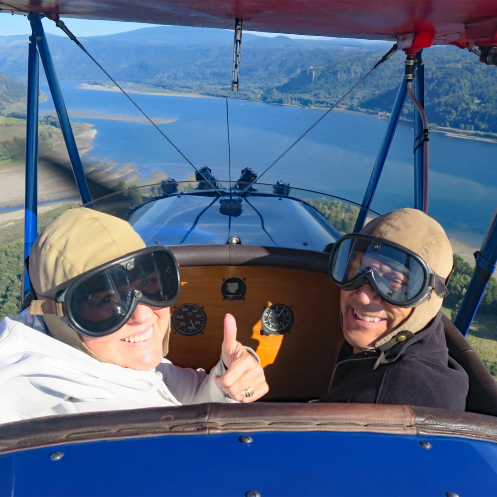 Passengers with Jim's Biplane Rides flying east up the Columbia River Gorge over Reed Island State Park