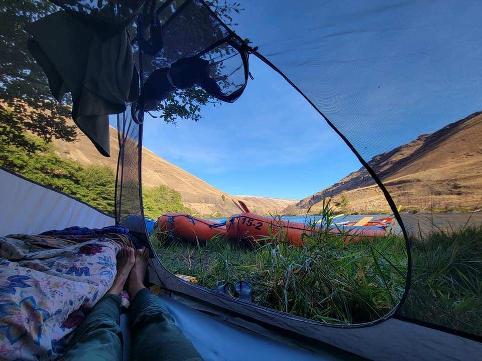 View of rafts and hills from inside tent