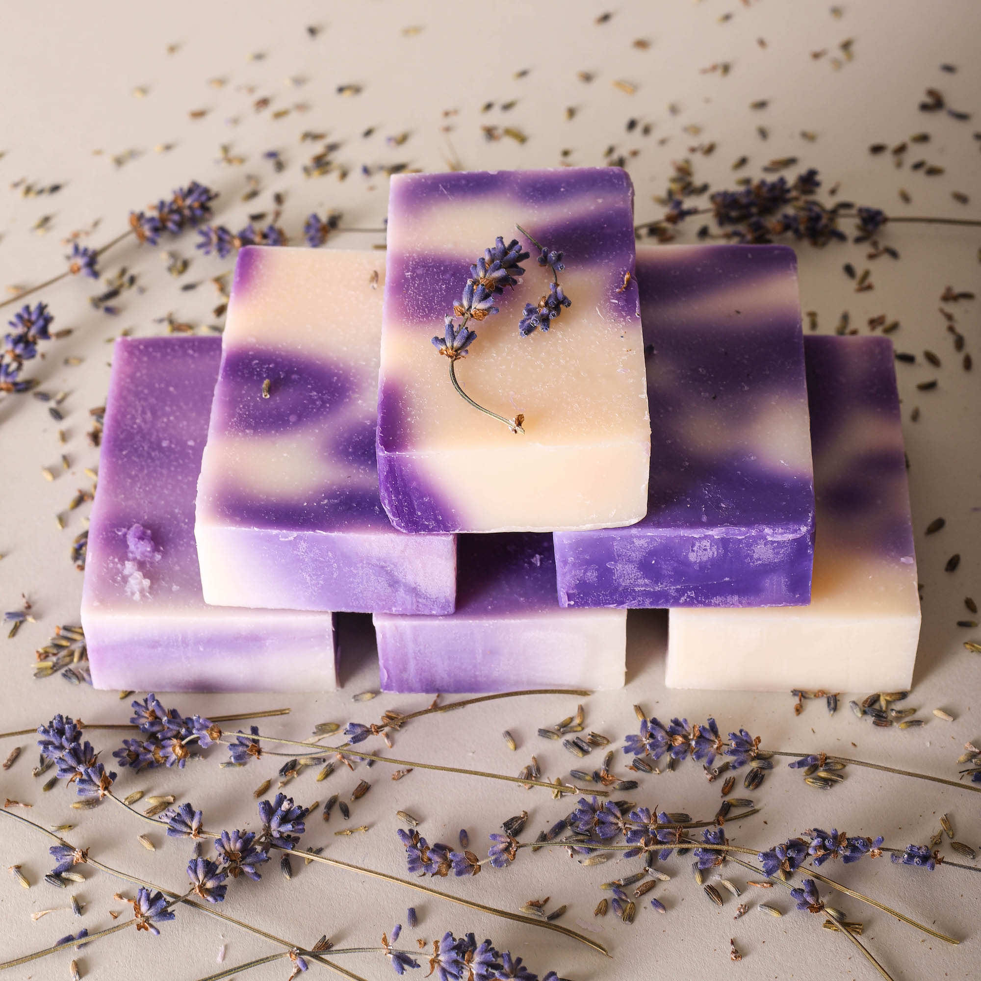 Stacked bars of purple and cream lavender soap