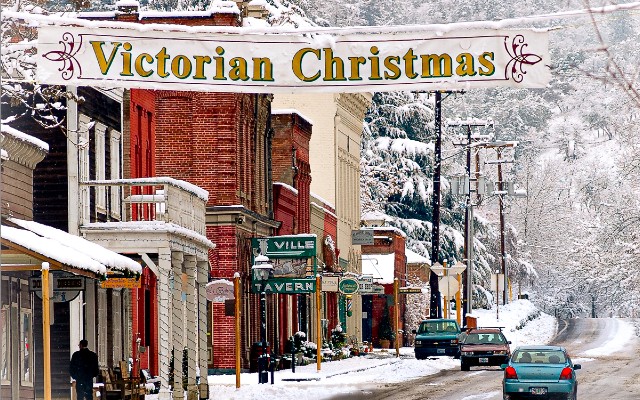 Street view of Jacksonville in the snow with Victorian Christmas sign over the street