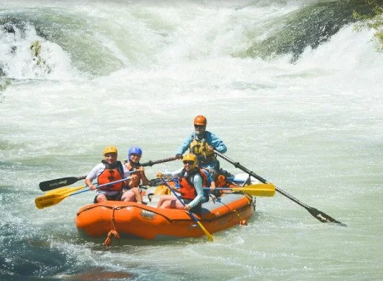 Rafting boat through white water rapids