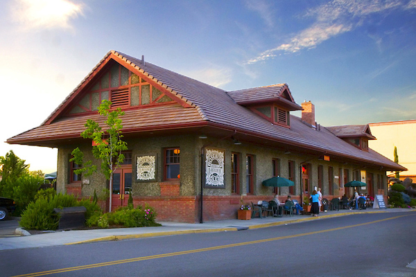 Side view with outdoor seating and trees and bushes