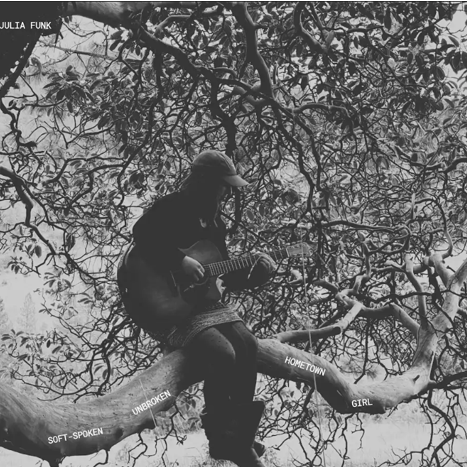 Julia Funk Album Release Party: Soft-Spoken Woman playing guitar in a tree