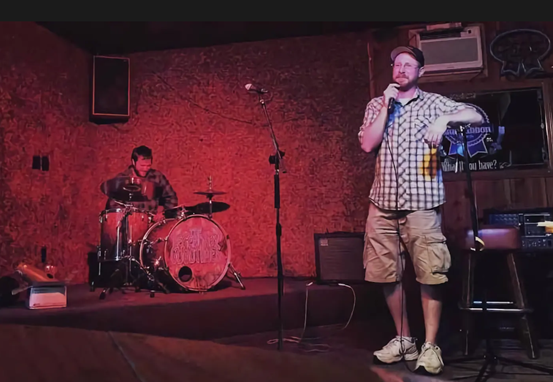 Man on Stage at Black Market Comedy