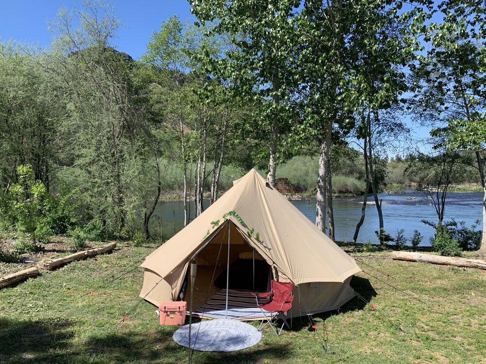 Campsite with tent next to a lake