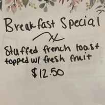 Breakfast special menu featuring stuffed french toast topped with fresh fruit.
