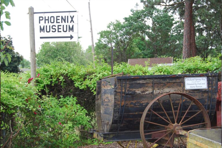 Phoenix Museum directional sign with old wagon with wheel