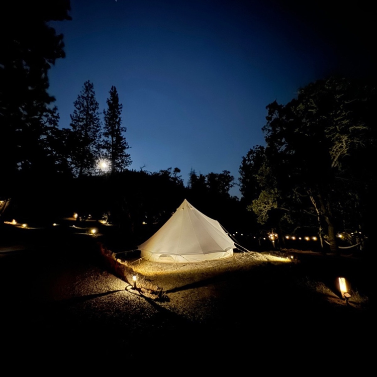 Outdoors at night with illuminated tent