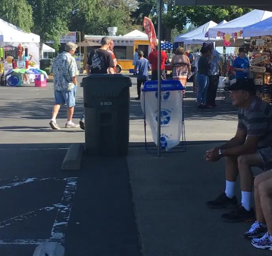 Group of vendor booths in a parking lot.