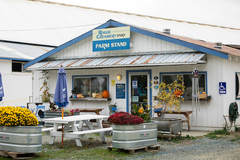 white picnic table in front of country farm stand