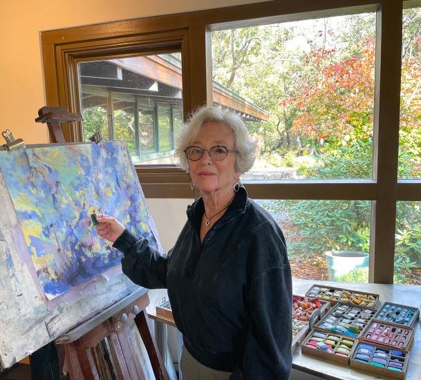 woman in art studio working with pastel