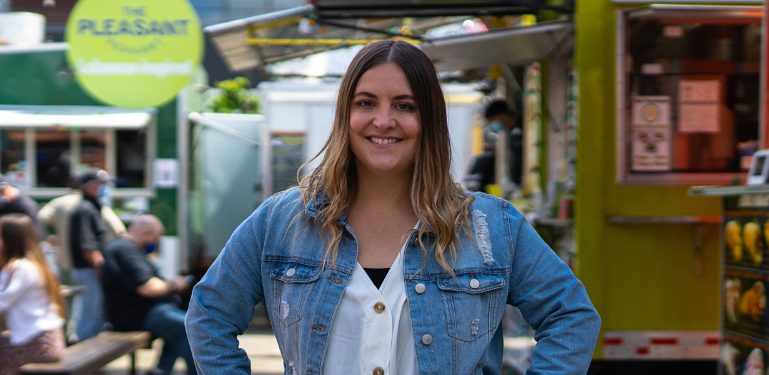 person smiling at camera standing outside