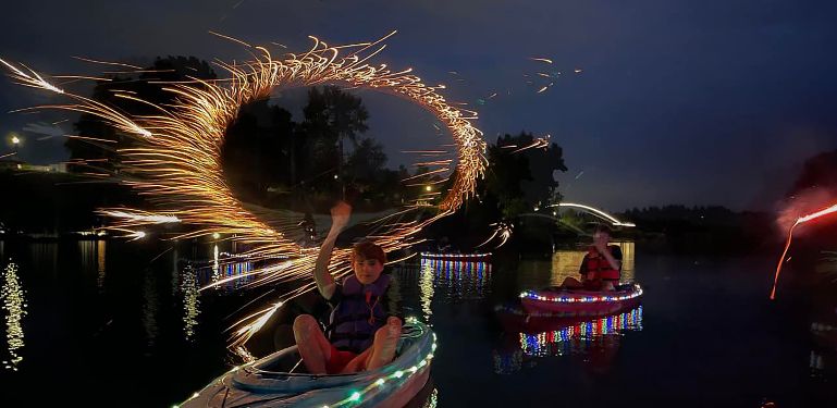 kayakers at night with lights