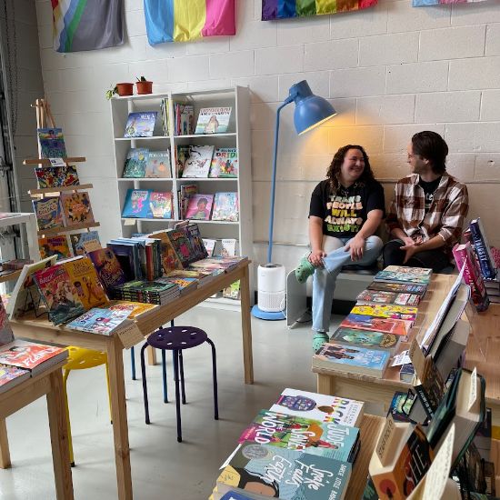 interior of book store with two people looking at each other smiling