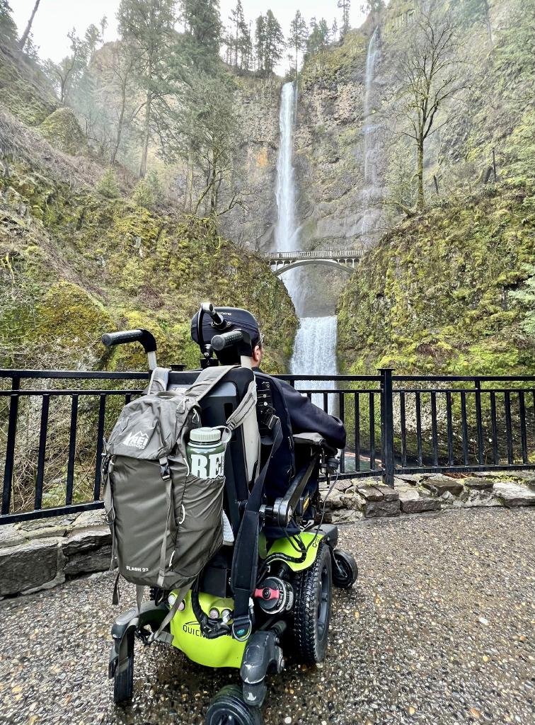 person in wheelchair viewing Multnomah Falls from accessible viewpoint