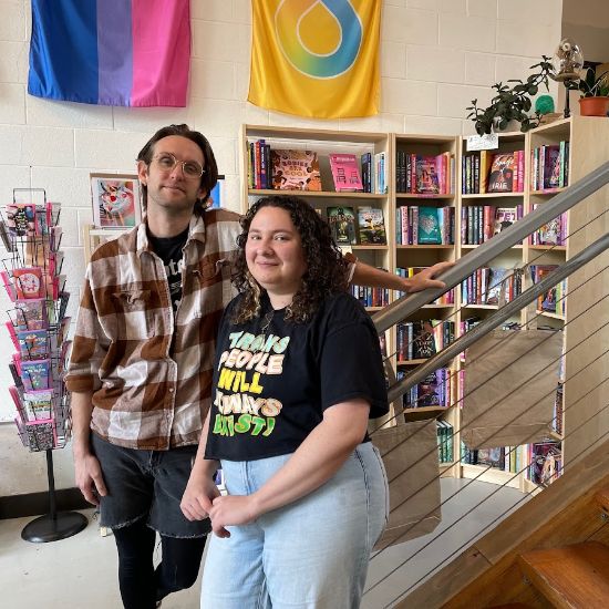 interior of bookstore with two people smiling at camera
