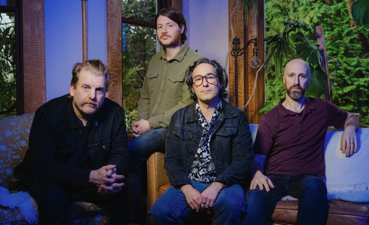 Four band members of Blitzen Trapper sitting on a couch